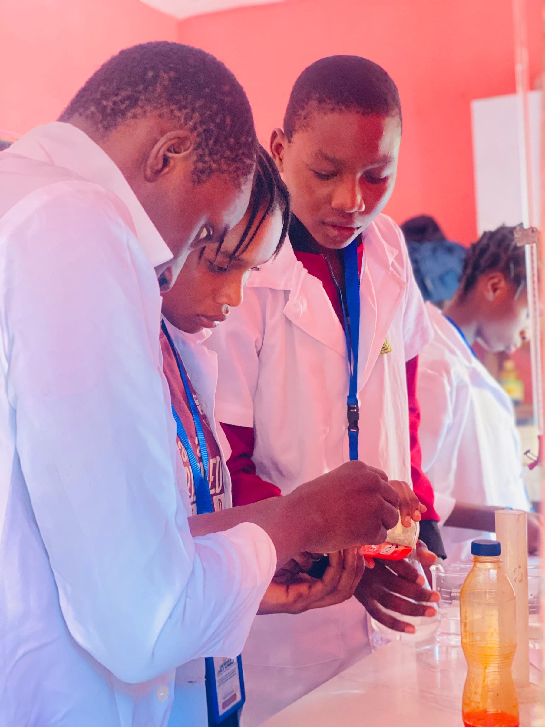 Students measuring and pouring a solution during a chemistry practical