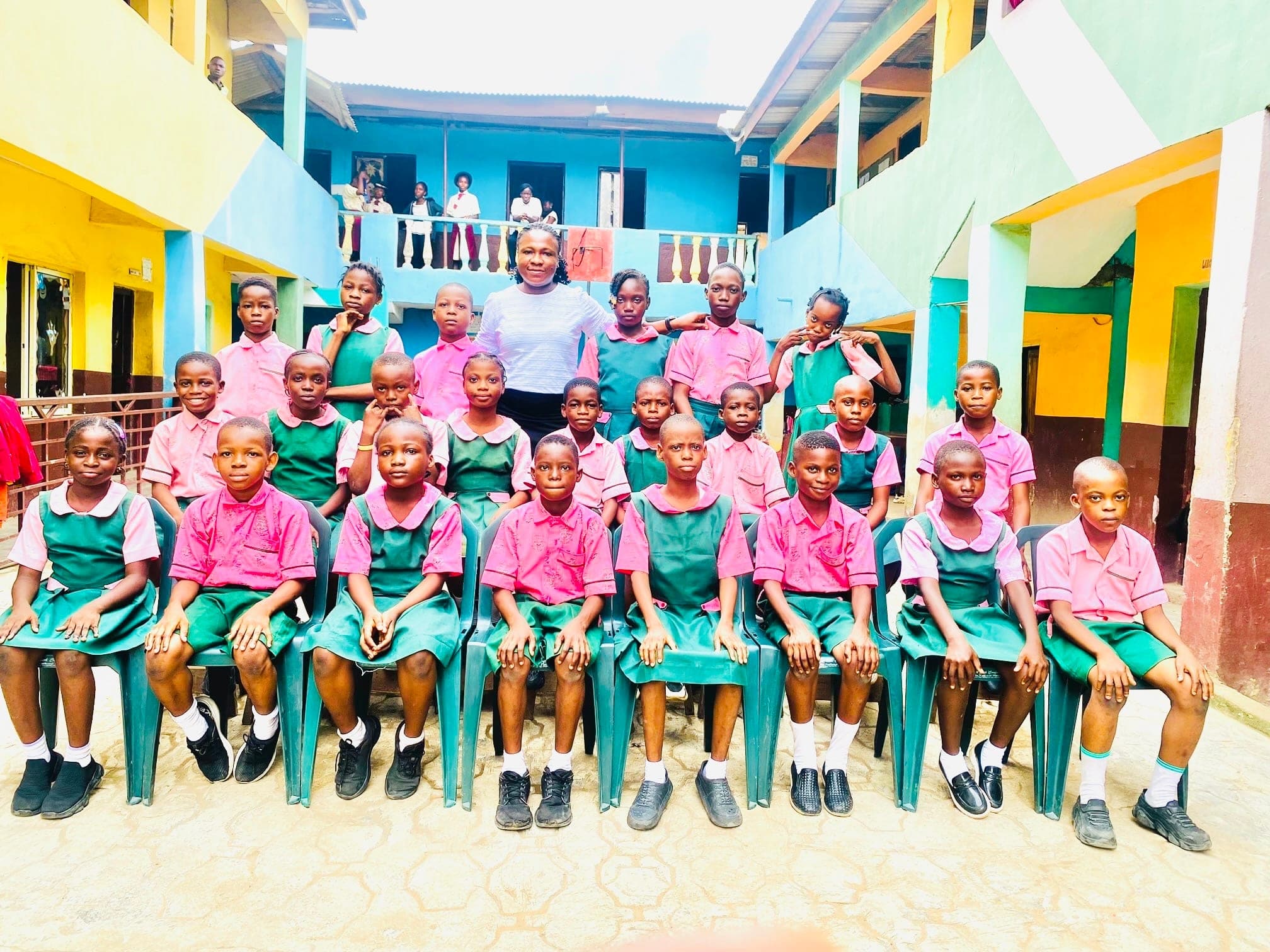 Primary pupils arranged in rows for a class photograph with their teacher